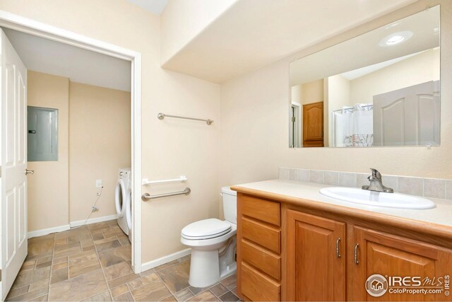 955 Sunchase Dr, Fort Collins, CO 80524 - bathroom featuring washer / dryer, electric panel, stone finish flooring, vanity, and toilet