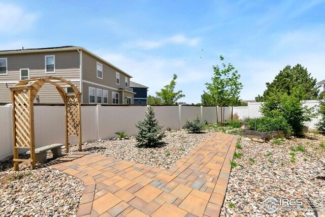 955 Sunchase Dr, Fort Collins, CO 80524 - view of patio with a garden, a fenced backyard, and a pergola