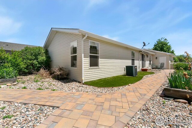 955 Sunchase Dr, Fort Collins, CO 80524 - rear view of property with central AC and a patio