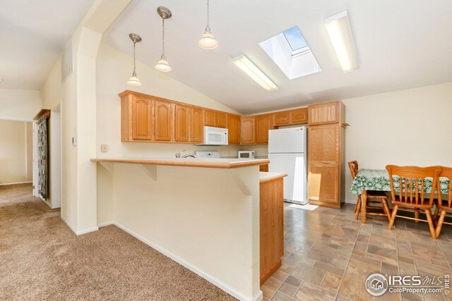955 Sunchase Dr, Fort Collins, CO 80524 - kitchen featuring white appliances, a skylight, light countertops, a peninsula, and lofted ceiling