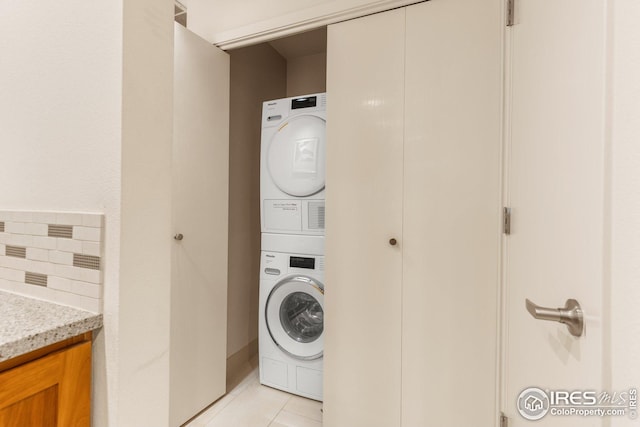 1140 Portland Pl Unit 207, Boulder, CO 80304 - washroom featuring stacked washer / dryer and light tile patterned floors