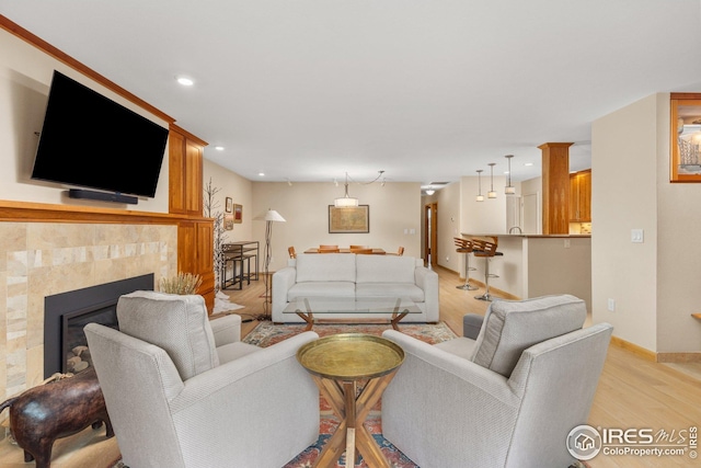 1140 Portland Pl Unit 207, Boulder, CO 80304 - living room with light wood-type flooring, baseboards, a tiled fireplace, and recessed lighting