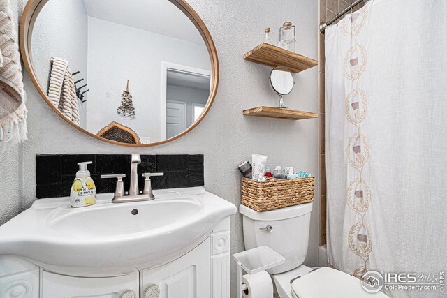 1001 Strachan Dr Unit 24, Fort Collins, CO 80525 - full bathroom featuring a textured wall, toilet, and vanity