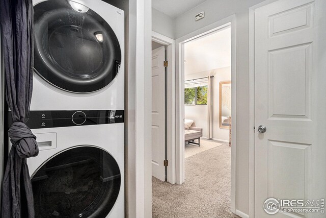 1001 Strachan Dr Unit 24, Fort Collins, CO 80525 - washroom featuring stacked washer / drying machine and carpet flooring