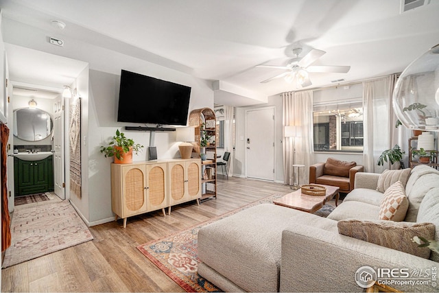 1001 Strachan Dr Unit 24, Fort Collins, CO 80525 - living room with ceiling fan, light wood-style floors, and baseboards