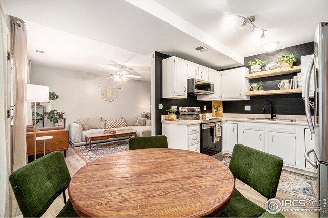 1001 Strachan Dr Unit 24, Fort Collins, CO 80525 - kitchen featuring appliances with stainless steel finishes, a sink, open floor plan, light countertops, and a ceiling fan