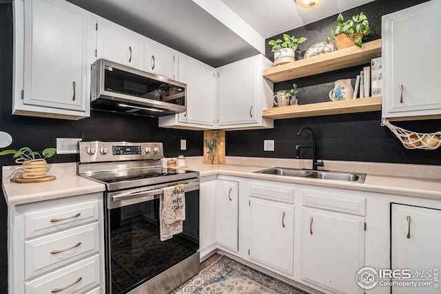 1001 Strachan Dr Unit 24, Fort Collins, CO 80525 - kitchen featuring appliances with stainless steel finishes, a sink, light countertops, and white cabinetry