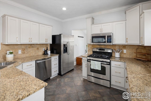 3039 W Denver Pl, Denver, CO 80211 - kitchen with stainless steel appliances, white cabinetry, light stone counters, crown molding, and backsplash