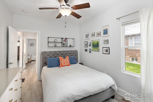 3039 W Denver Pl, Denver, CO 80211 - bedroom with light wood-style floors, a ceiling fan, and baseboards