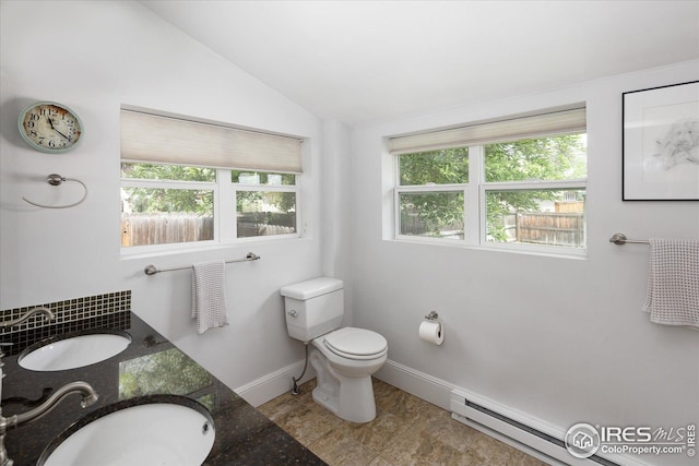 3039 W Denver Pl, Denver, CO 80211 - bathroom featuring healthy amount of natural light, vaulted ceiling, toilet, baseboards, and baseboard heating