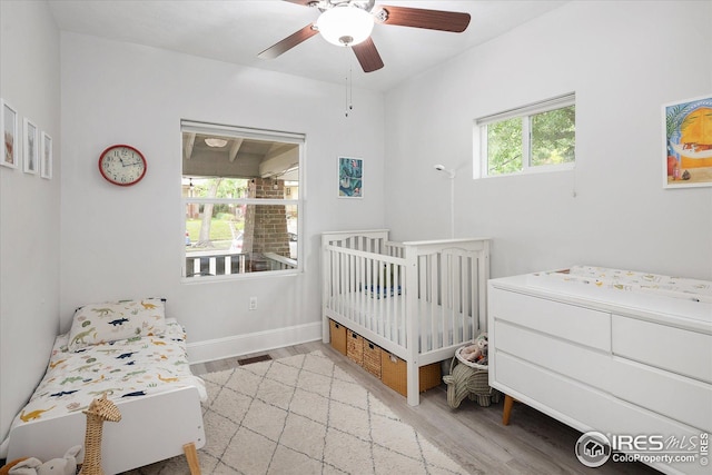 3039 W Denver Pl, Denver, CO 80211 - bedroom featuring wood finished floors, a ceiling fan, baseboards, and a nursery area