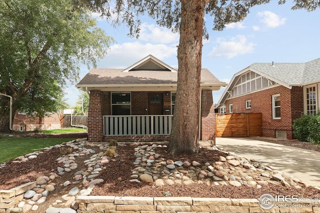 3039 W Denver Pl, Denver, CO 80211 - view of front of home with brick siding, covered porch, driveway, and roof with shingles