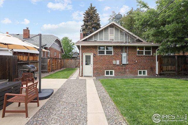 3039 W Denver Pl, Denver, CO 80211 - back of property featuring brick siding, a patio, a shingled roof, and a chimney