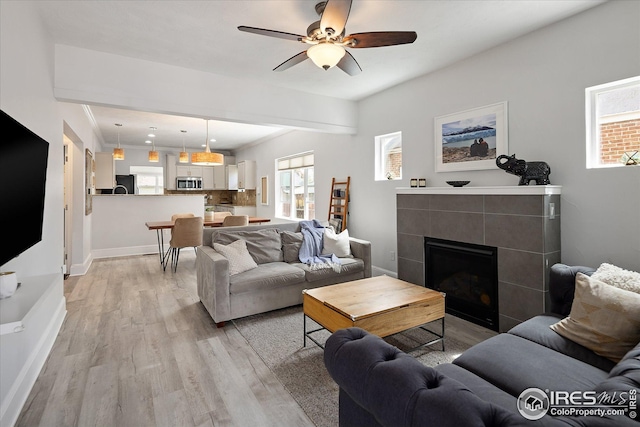 3039 W Denver Pl, Denver, CO 80211 - living room featuring ceiling fan, light wood-style floors, plenty of natural light, and baseboards