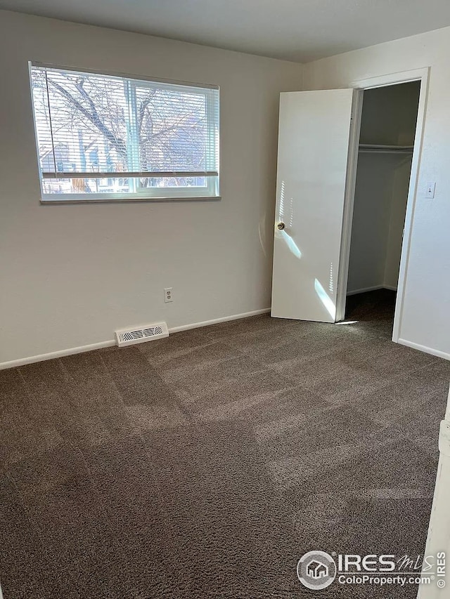 712 Meeker St, Longmont, CO 80504 - unfurnished bedroom featuring carpet, baseboards, a closet, and a spacious closet