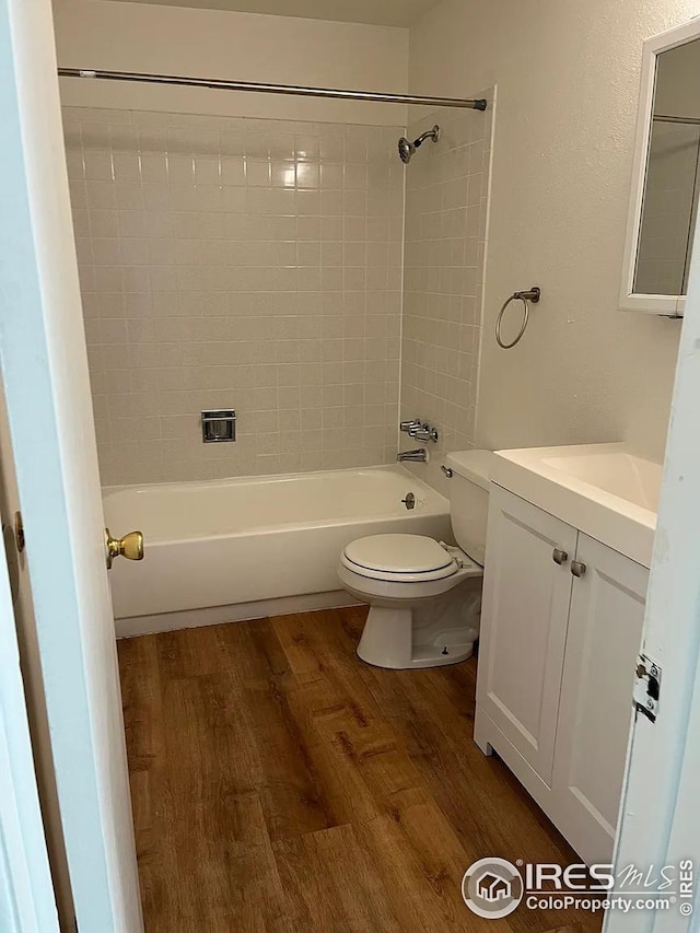 712 Meeker St, Longmont, CO 80504 - bathroom with toilet, shower / tub combination, wood finished floors, and vanity