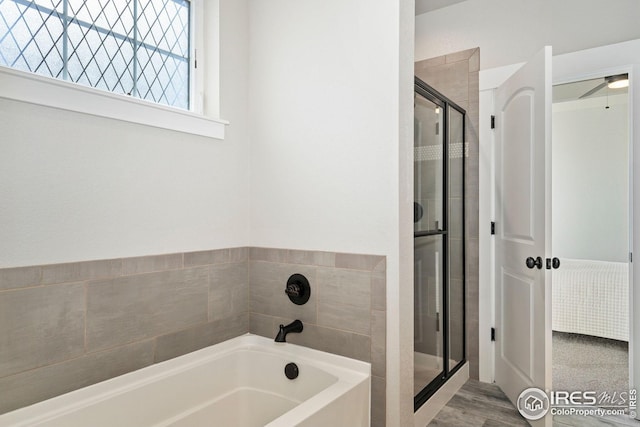 2497 Trio Falls Dr, Loveland, CO 80538 - bathroom with a bath, a shower stall, and a ceiling fan