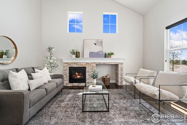 2497 Trio Falls Dr, Loveland, CO 80538 - living room with a fireplace, high vaulted ceiling, and wood finished floors