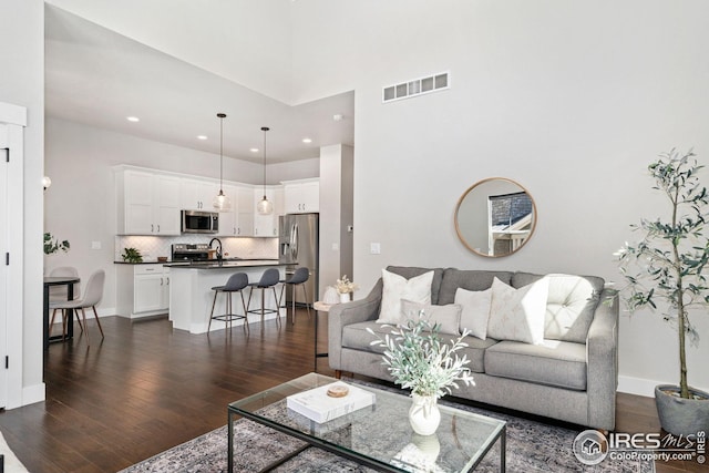 2497 Trio Falls Dr, Loveland, CO 80538 - living area with dark wood finished floors, recessed lighting, and baseboards