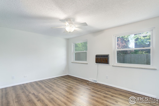 2620 Lloyd Cir, Boulder, CO 80304 - spare room with wood finished floors, a ceiling fan, a textured ceiling, a wall mounted air conditioner, and baseboards