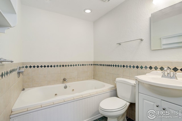 2620 Lloyd Cir, Boulder, CO 80304 - full bath featuring a whirlpool tub, toilet, vanity, and a wainscoted wall
