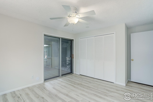 2620 Lloyd Cir, Boulder, CO 80304 - unfurnished bedroom featuring wood finished floors, a textured ceiling, access to outside, a closet, and baseboards