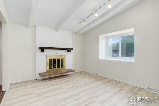 2620 Lloyd Cir, Boulder, CO 80304 - unfurnished living room featuring wood finished floors, a brick fireplace, beamed ceiling, and baseboards