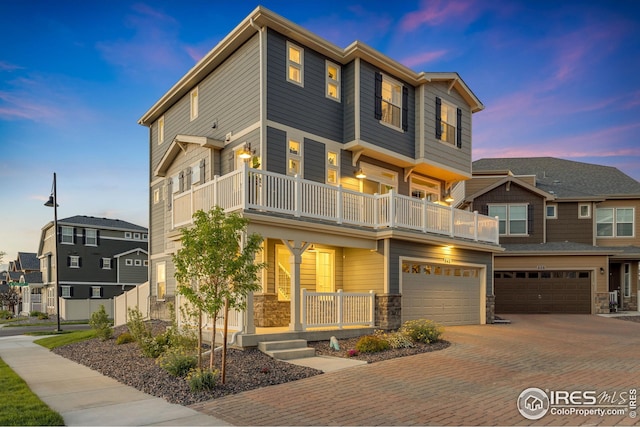542 Highlands Cir, Erie, CO 80516 - multi unit property with a balcony, covered porch, decorative driveway, and stone siding