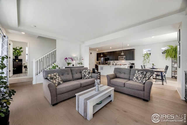 542 Highlands Cir, Erie, CO 80516 - living room featuring light wood-type flooring, stairway, and recessed lighting