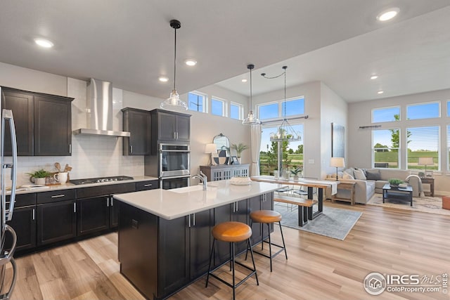 6752 Castello St, Timnath, CO 80547 - kitchen with wall chimney exhaust hood, gas stovetop, double oven, healthy amount of natural light, and recessed lighting