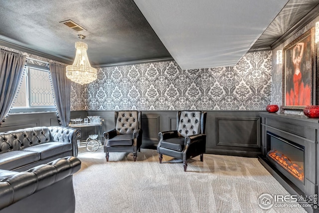 1006 4th St, Pierce, CO 80650 - living area featuring a chandelier, wallpapered walls, carpet flooring, a wainscoted wall, and a glass covered fireplace