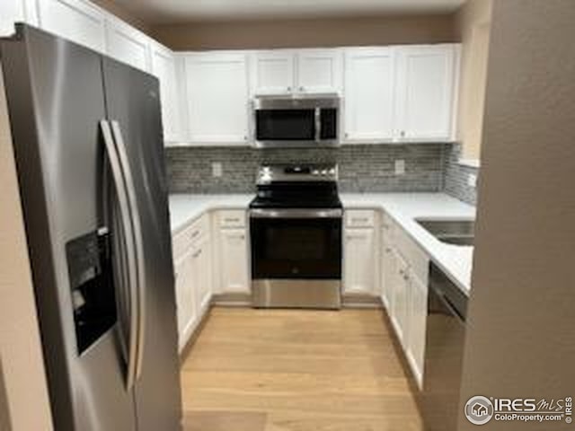 2218 Stetson Creek Dr Unit C, Fort Collins, CO 80528 - kitchen featuring stainless steel appliances, decorative backsplash, and white cabinets