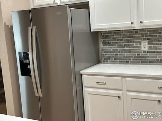 2218 Stetson Creek Dr Unit C, Fort Collins, CO 80528 - kitchen featuring stainless steel fridge, tasteful backsplash, white cabinetry, and light countertops