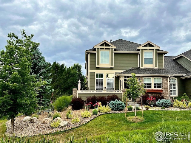 2639 County Fair Ln, Fort Collins, CO 80528 - view of front of house with a shingled roof and a front yard
