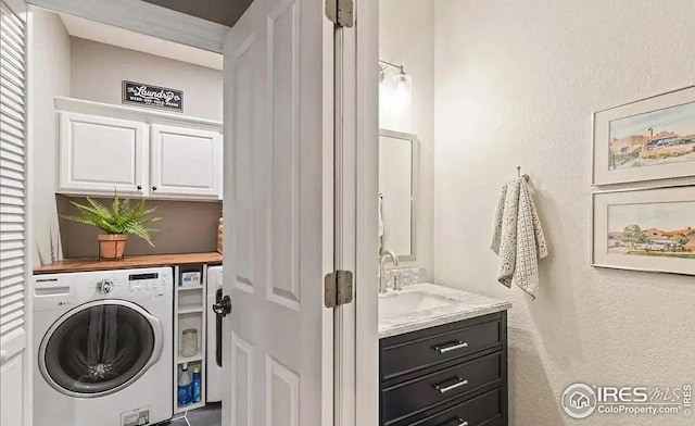 2639 County Fair Ln, Fort Collins, CO 80528 - washroom with washer / dryer, cabinet space, and a textured wall