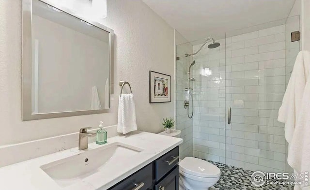 2639 County Fair Ln, Fort Collins, CO 80528 - bathroom with vanity, a shower stall, toilet, and a textured wall