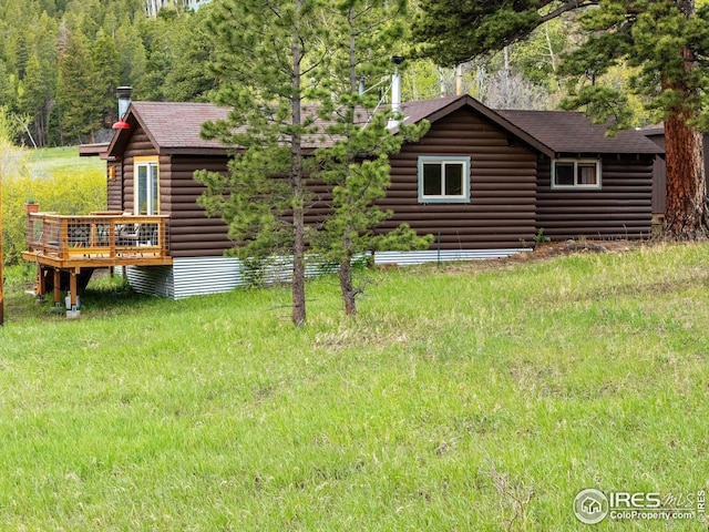 175 Ironclad View Rd, Allenspark, CO 80510 - rear view of property featuring a deck, a shingled roof, log veneer siding, and a view of trees