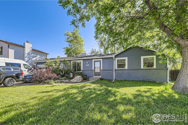 10718 Owens St, Broomfield, CO 80021 - ranch-style house with entry steps, brick siding, and a front lawn