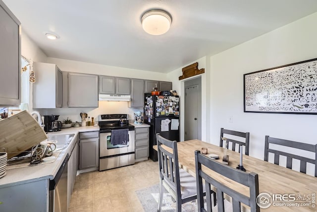 10718 Owens St, Broomfield, CO 80021 - kitchen featuring appliances with stainless steel finishes, under cabinet range hood, gray cabinets, light countertops, and a sink