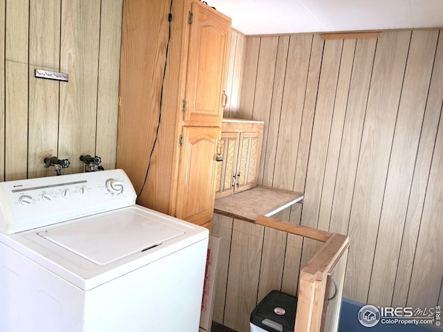 402 N Washington Ave, Fleming, CO 80728 - laundry area with washer / clothes dryer, cabinet space, and wood walls