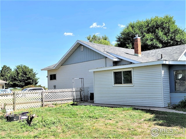 402 N Washington Ave, Fleming, CO 80728 - back of house featuring a chimney and roof with shingles