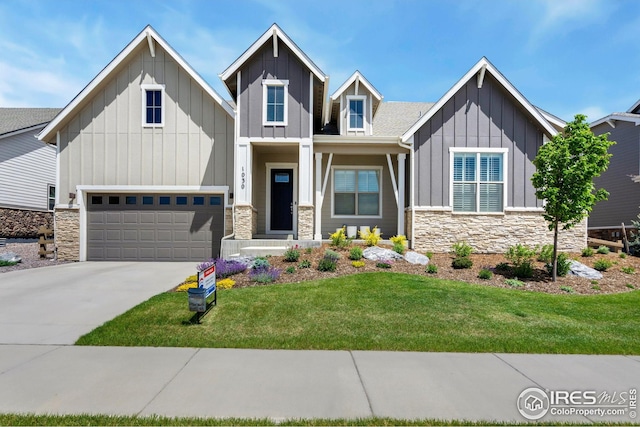 1030 Larimer Ridge Pkwy, Timnath, CO 80547 - craftsman-style home with board and batten siding, stone siding, a front lawn, and driveway