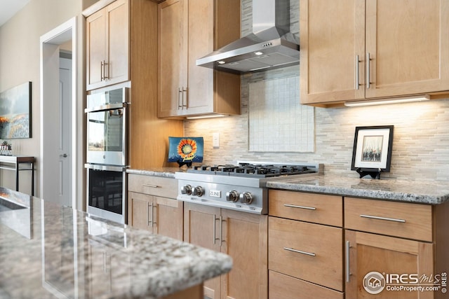 1030 Larimer Ridge Pkwy, Timnath, CO 80547 - kitchen featuring wall chimney range hood, stainless steel appliances, tasteful backsplash, and light brown cabinetry