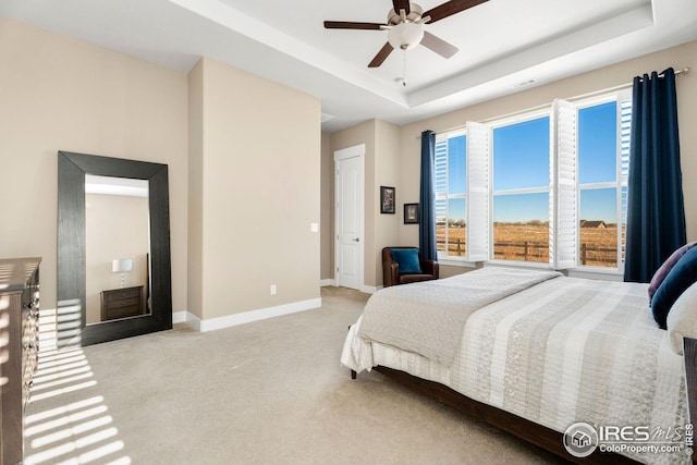 1030 Larimer Ridge Pkwy, Timnath, CO 80547 - bedroom with light carpet, baseboards, a raised ceiling, and a ceiling fan