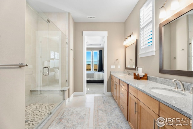 1030 Larimer Ridge Pkwy, Timnath, CO 80547 - ensuite bathroom with double vanity, healthy amount of natural light, a shower stall, and tile patterned flooring