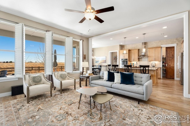 1030 Larimer Ridge Pkwy, Timnath, CO 80547 - living room featuring healthy amount of natural light, light wood-style flooring, ceiling fan, and recessed lighting