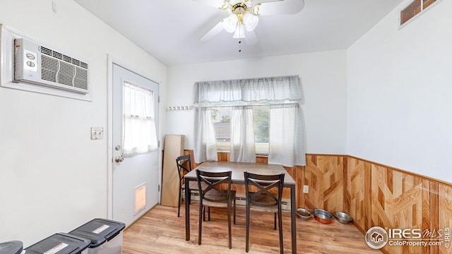 8208 Peakview Dr, Fort Collins, CO 80528 - dining room with wood finished floors, a ceiling fan, a wall mounted AC, and a wainscoted wall