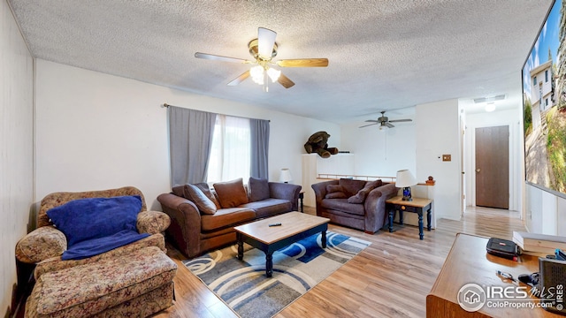 8208 Peakview Dr, Fort Collins, CO 80528 - living area with ceiling fan, light wood finished floors, and a textured ceiling