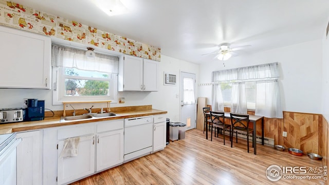 8208 Peakview Dr, Fort Collins, CO 80528 - kitchen with white dishwasher, a sink, ceiling fan, light wood-style floors, and a baseboard heating unit