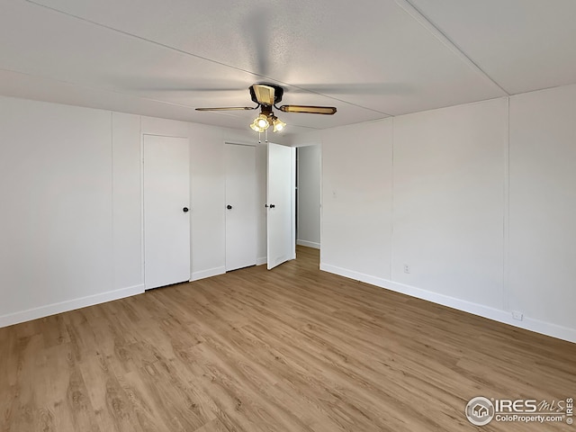 306 E Arapahoe St, Fleming, CO 80728 - unfurnished bedroom featuring light wood-type flooring, baseboards, and a ceiling fan